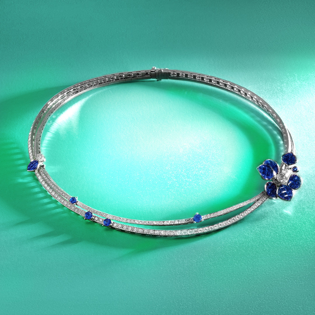Diamond Necklace with blue Sapphire Flower on a green background